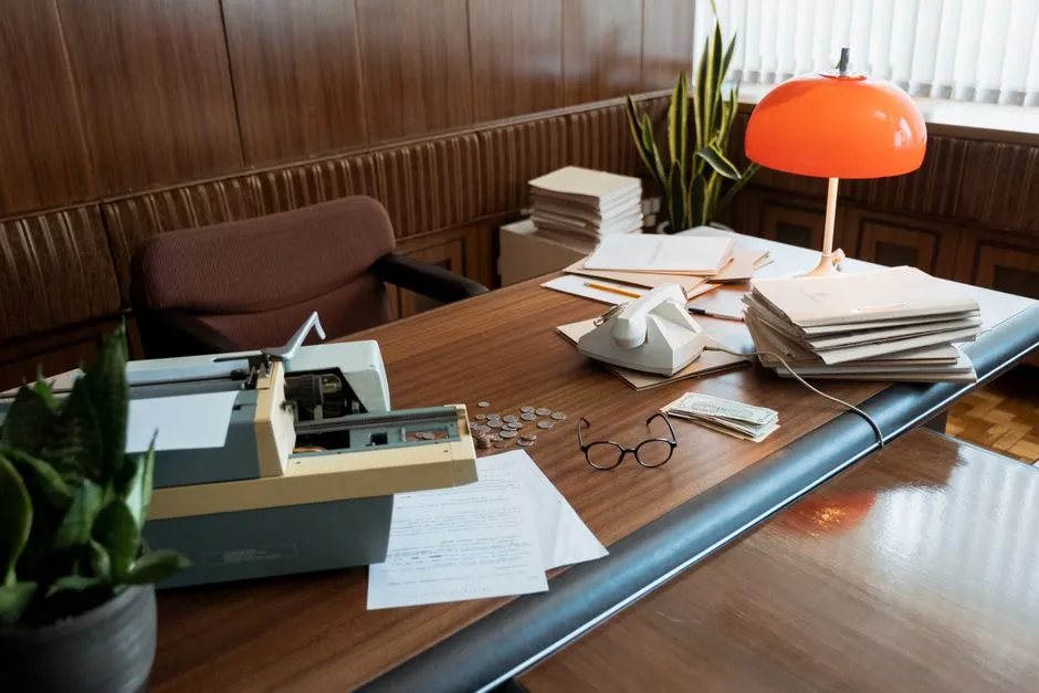 Typewriter and printed documents on a desk, illustrating a formatted business letter